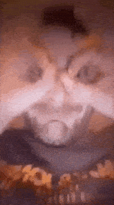 a close up of a man with a beard making a funny face with his hands .