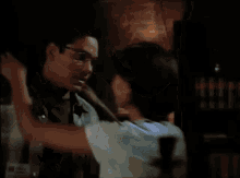 a man and a woman kissing in a dark room