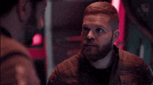 a man with a beard is talking to another man with the words like a fucking pharaoh below him