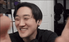 a close up of a man 's face with his eyes closed and his mouth open