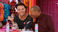 two men are sitting next to each other and one of them is holding a can of pink soda