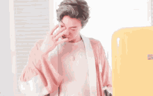 a man in a pink robe is standing in front of a smeg refrigerator