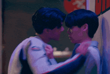 two men are hugging each other and looking at each other .