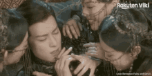 a man is surrounded by a group of women and the words love between fairy and devil are on the bottom