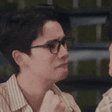 a man in a striped shirt is making a face