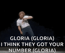 a man is dancing on a stage with the words `` gloria ( gloria ) i think they got your number ''