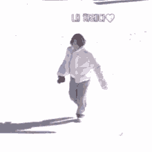 a person in a white jacket is standing in the snow .