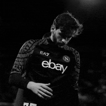 a black and white photo of a man wearing a shirt that says ebay