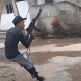 a man is swinging on a swing with a gun in his hand