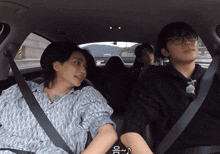 a man and a woman are sitting in a car and the woman is wearing a shirt that says dior