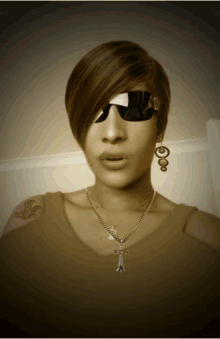 a woman wearing sunglasses and a necklace with a cross