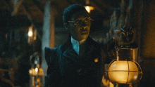 a woman in a striped suit holds a lantern