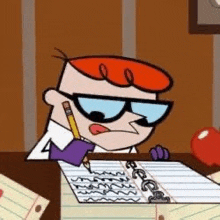 dexter is sitting at a desk writing in a notebook .