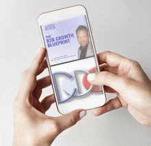 a person is holding a cell phone that says the b2b growth blueprint on the screen