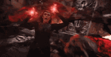 a person is being attacked by a group of zombies with red lights coming out of their mouths .