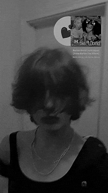 a black and white photo of a girl with a barbie world cd