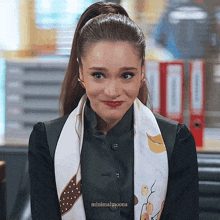 a woman wearing a scarf and a ponytail is smiling with minimalmoons written on the bottom