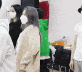 a group of people wearing face masks are standing together