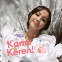 a woman is surrounded by white flowers with the words kamu keren written in red