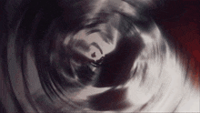 a person 's silhouette is visible in a dark tunnel