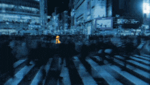 a person in a yellow raincoat crosses a crowded street