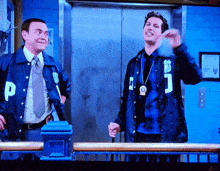 two police officers wearing jackets with the letter p on them