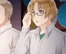 a young boy wearing glasses is standing next to a man .
