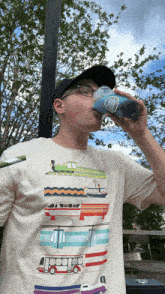 a man wearing a t-shirt that has a picture of a bus on it