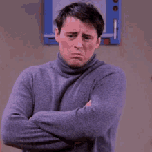 a man in a turtleneck sweater is saying he 's breathing .