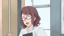a woman wearing glasses and a white shirt is standing in front of a window