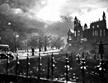 a black and white photo of a cemetery and castle