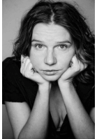 a black and white photo of a woman 's face with her hands on her chin