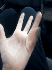 a close up of a person 's hand with a blurred background