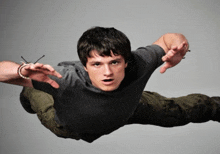 a man is flying through the air with his arms outstretched