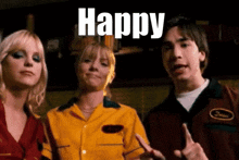 a man and two women are standing next to each other with the word happy in white letters
