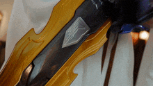 a close up of a sword with a silver emblem
