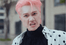 a man with pink hair is making a funny face with his mouth open