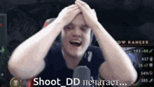 a man with his hands on his head and the words shoot dd on the bottom