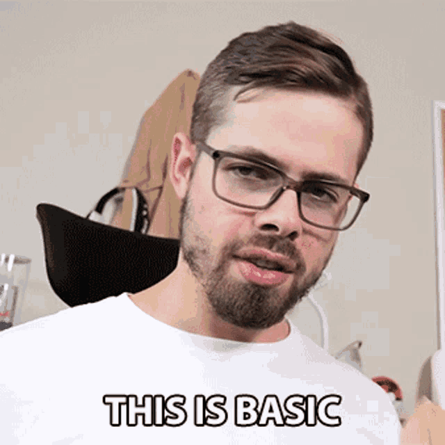 a man wearing glasses and a white shirt says " this is basic "