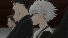 a group of anime characters are sitting in a line