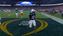 a football player with the number 10 on his jersey stands on the field