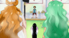 a man with a straw hat stands between two women