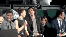 a man and a woman are sitting next to each other on a stage and talking to each other .
