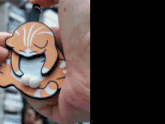 a close up of a person holding a cat shaped ornament