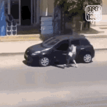a man is getting out of a car on a street .