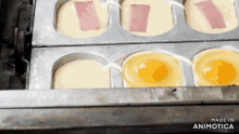 eggs and ham are being cooked in a pan that says made in animatica