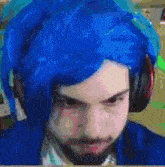 a man with blue hair is wearing headphones and a blue jacket .