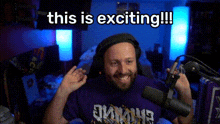 a man in a purple vikings shirt is holding a microphone in front of a screen that says this is exciting !!!
