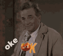 a man in a suit and tie is holding a tomato with a face on it and says oke