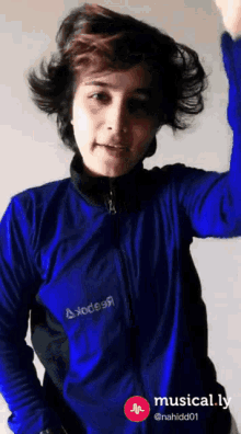 a person wearing a blue jacket with the word axodes on it